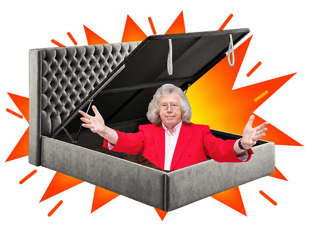 Mattress Mick sitting in an open grey gas-lift storage bed